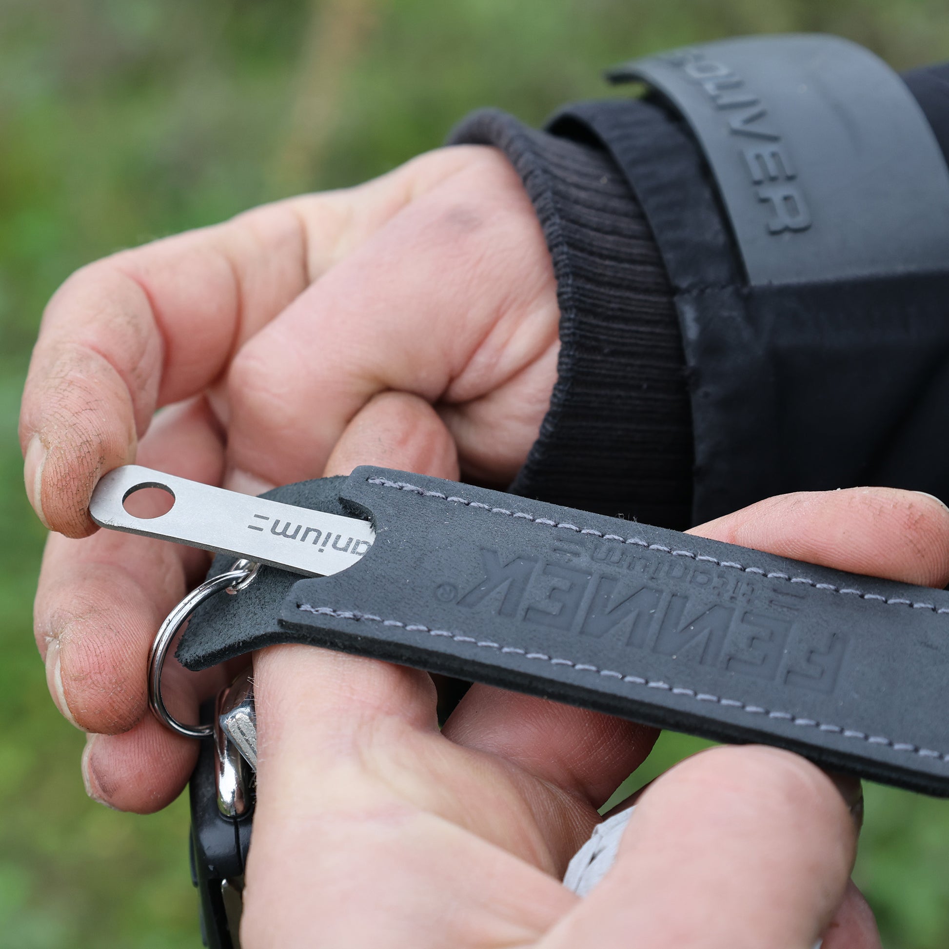 Pieker Pommesgabel wird in das schwarze Leder-Etui mit geprägtem Logo hineingeschoben